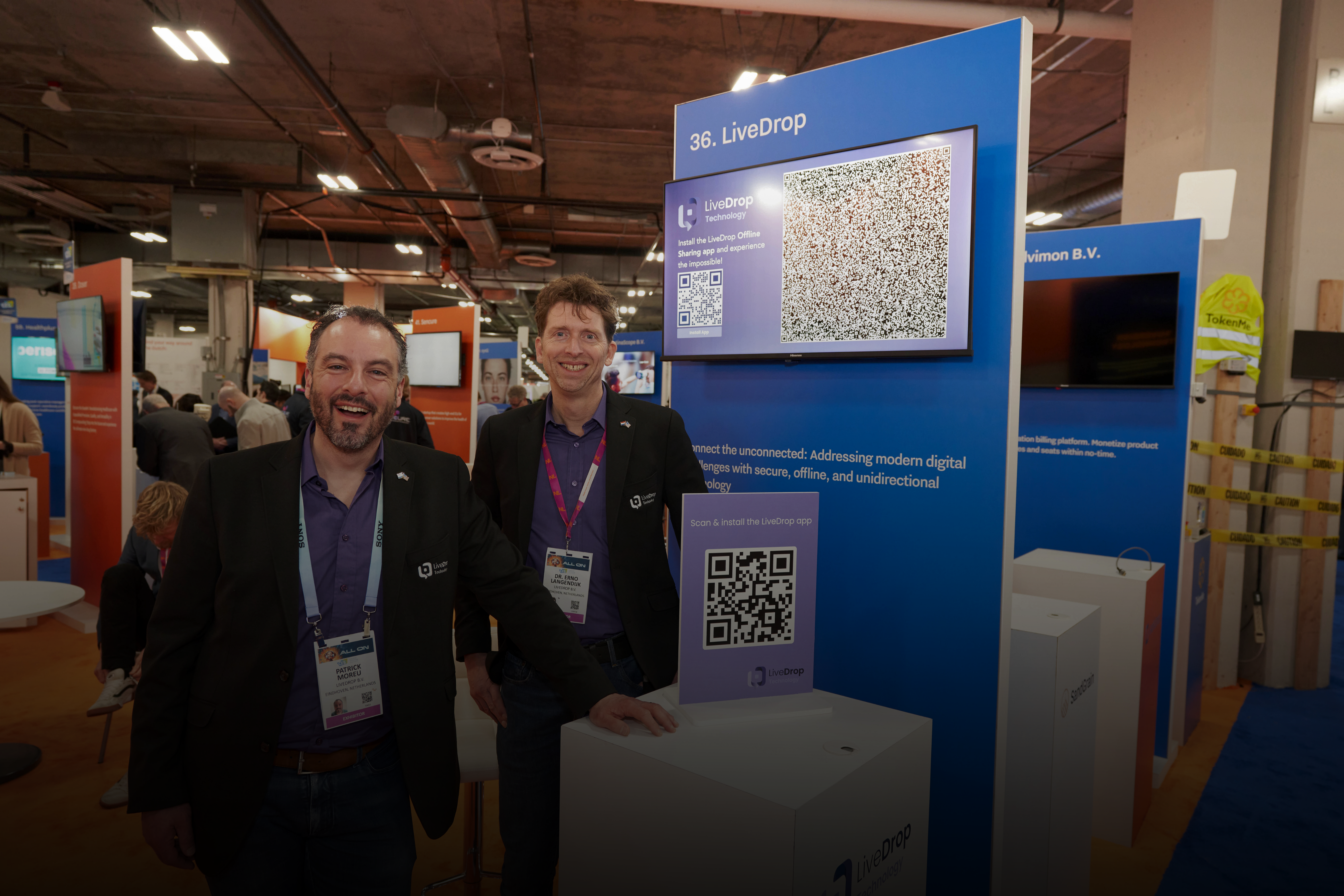 Cofounders of LiveDrop at their stand at CES 2024
