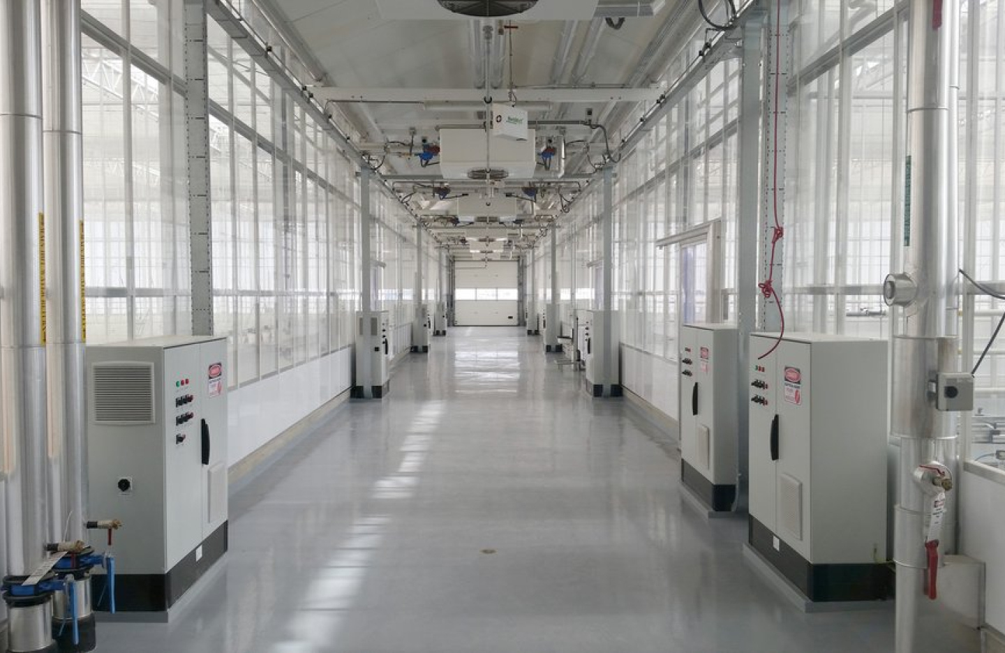 The hallway of a research facility for agriculture. Lined with machinery. 