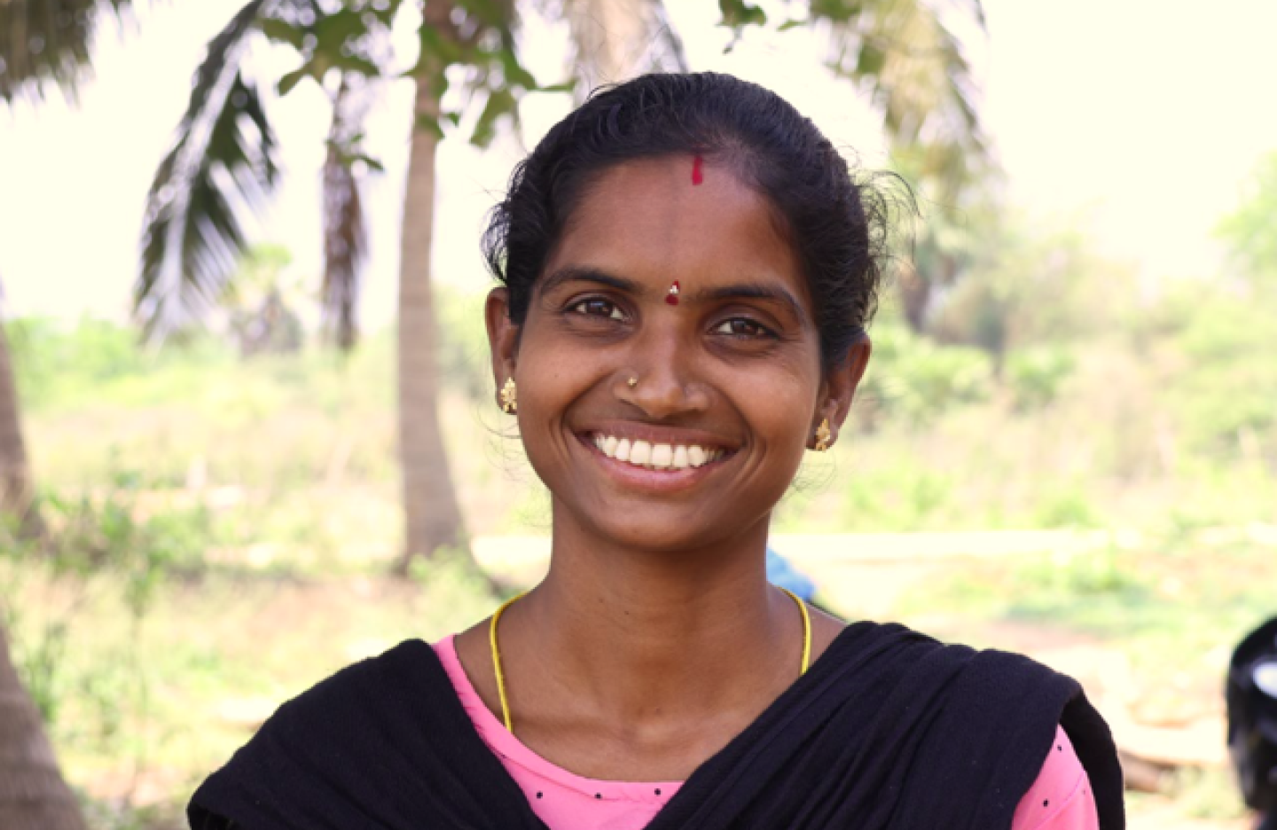 An Indian farmer lady from the Eastern Ghats smiles for the camera in a portrait picture