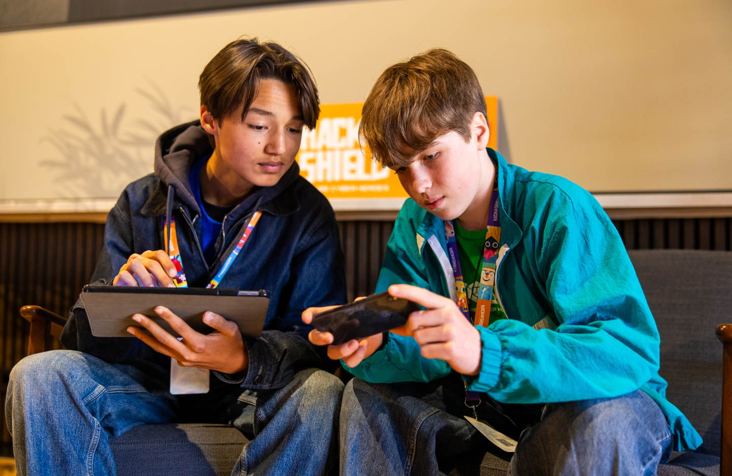 Two boys working on their digital devices.