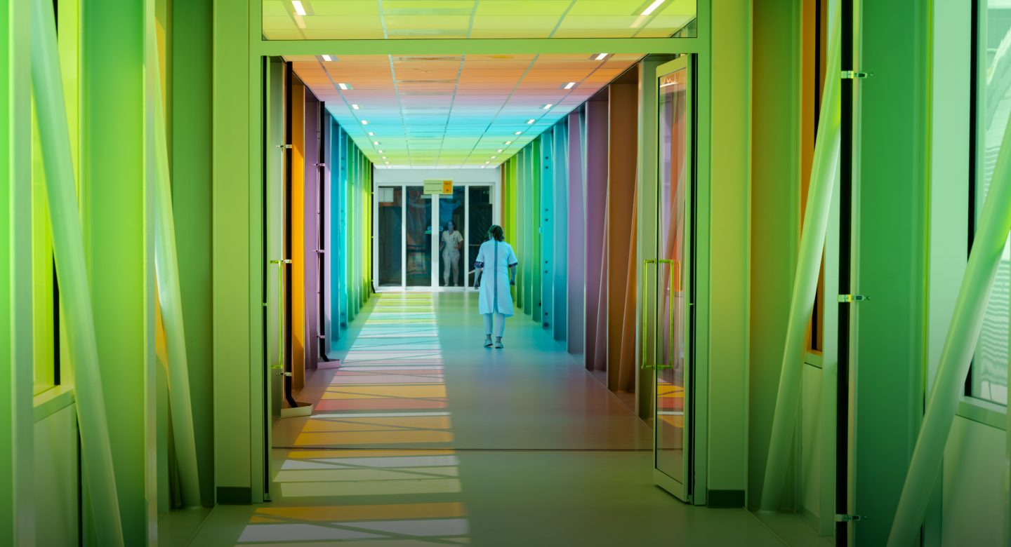 Scientist walking in coloured hallway