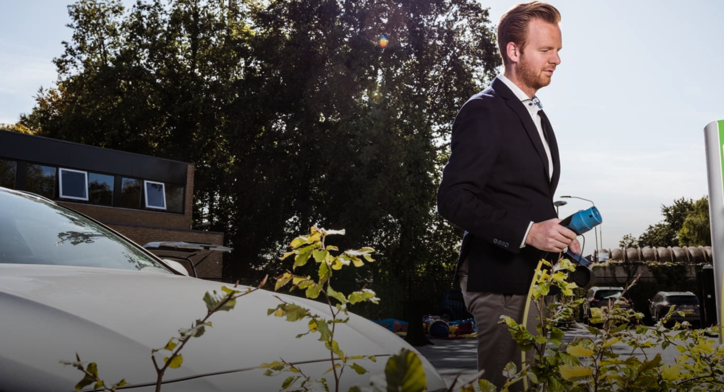 Man-connects-electric-car-to-charging-point.