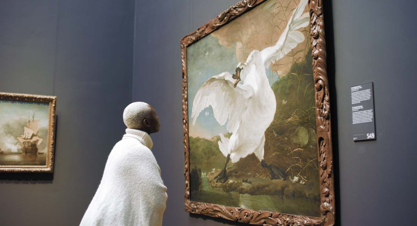 Person looking at painting in museum