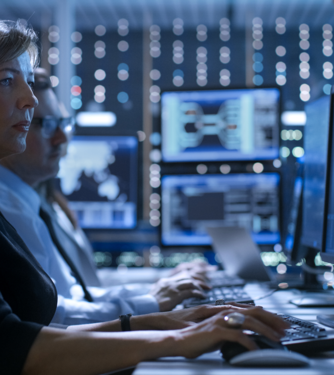 Woman sitting upright behind computer screen