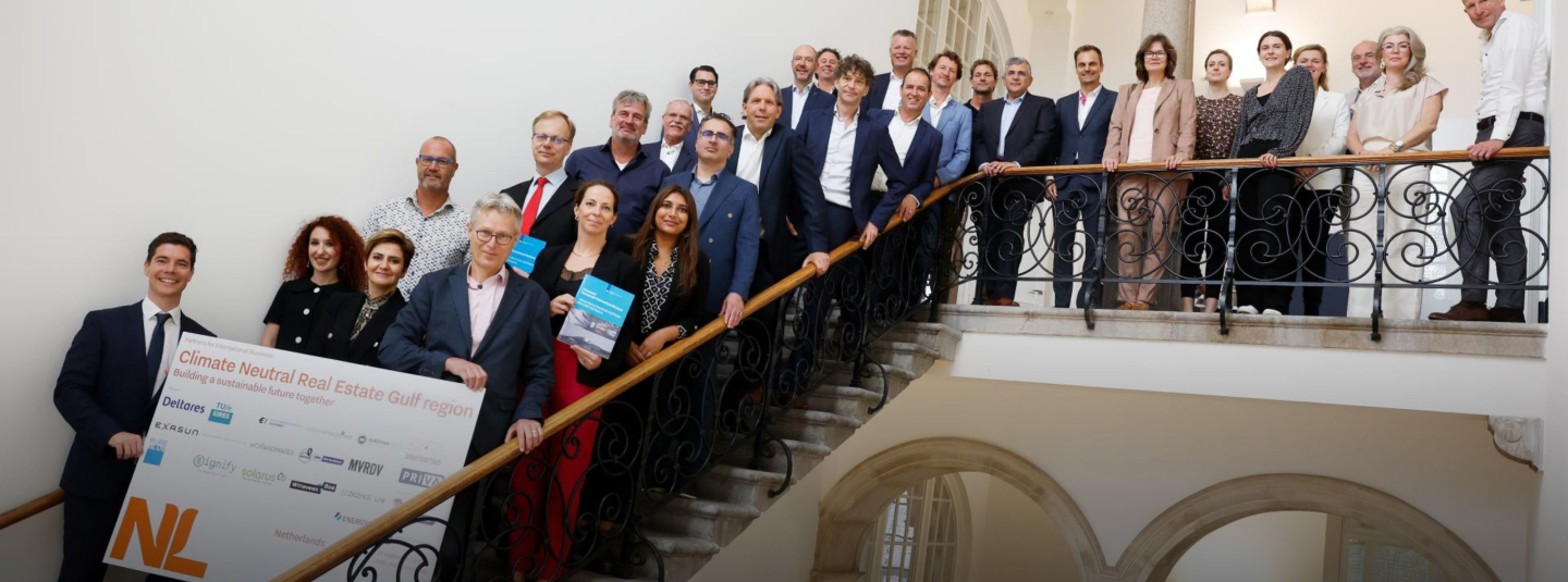 PIB members stand on a staircase with their PIB signing board on display