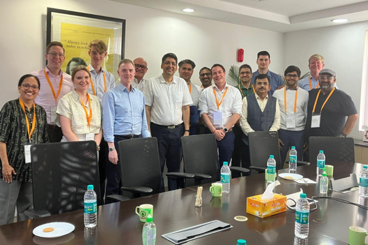 pib members gathered around a boardroom table for a group picture