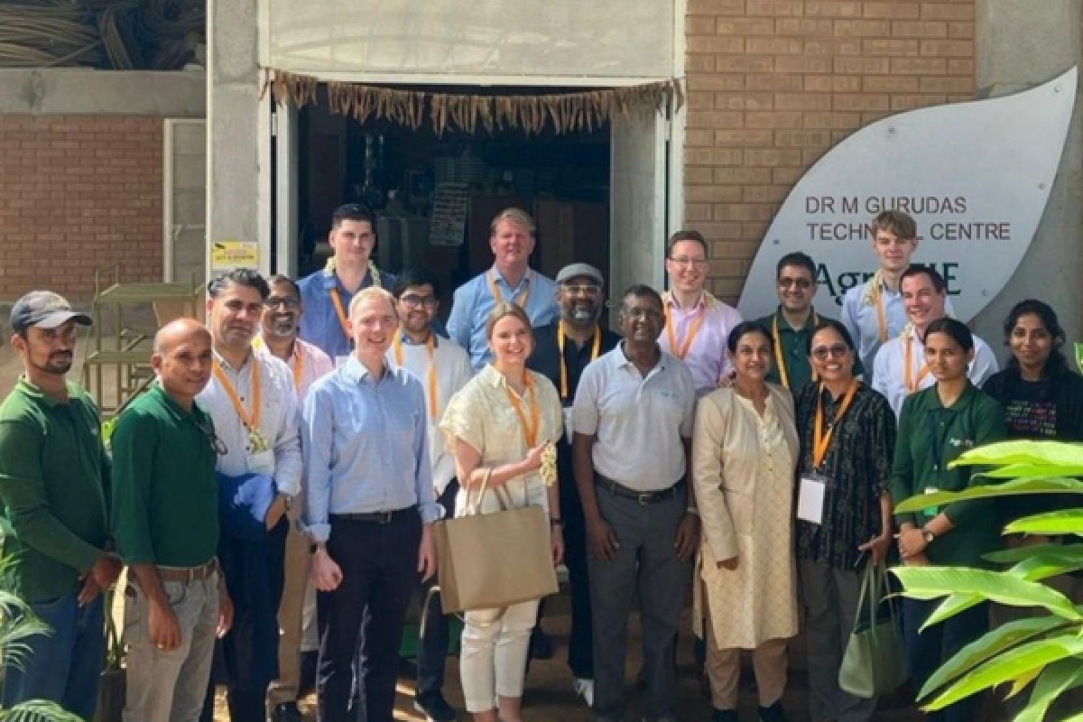 pib memebers in India pose for a group picture in a doorway as the Indian sun shines on them