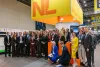 A group of participants in the ReBuild Ukraine 2025 mission take a group picture at the NL Pavilion.